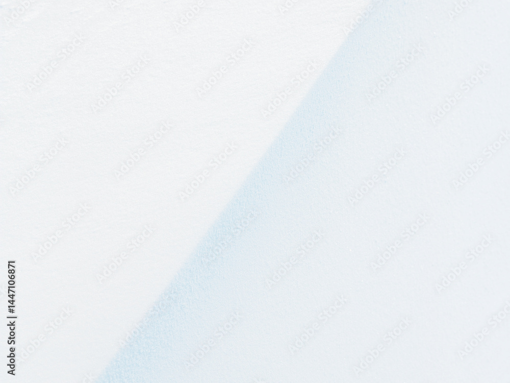 Beautiful winter background with snowy ground. Natural snow texture. Wind sculpted patterns on snow surface.