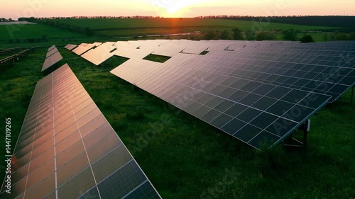 Aerial view of a solar farm generating clean energy.Solar panels park generating green energy electric at sunset..Green energy reduce carbon emissions and makes earth cleaner and more ecological	