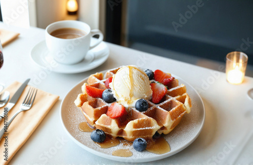 Indulgent waffle dessert with ice cream and fresh berries. with hot coffee