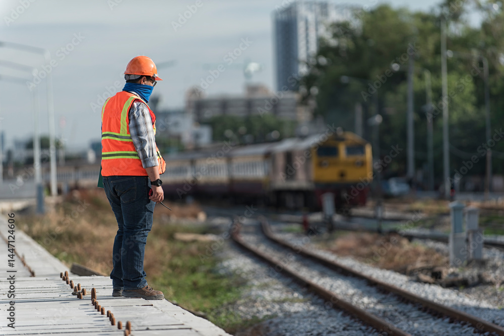 Obraz premium Engineer Inspecting Railway Track During Construction