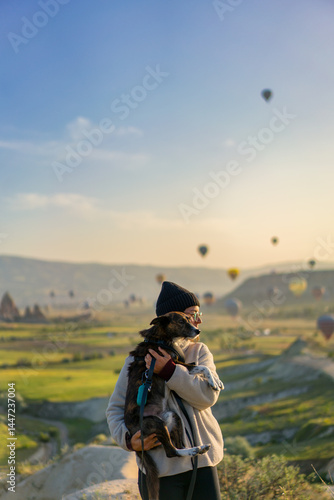 Wallpaper Mural Tourist hugging her dog with hot air balloons flying over Cappad Torontodigital.ca