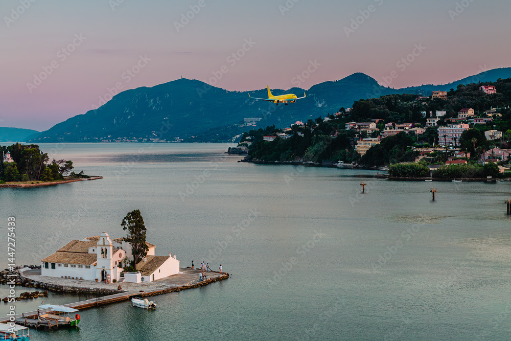 Typical view of Vlacherna Monastery and Mouse island with airplane landing, Corfu, Greece