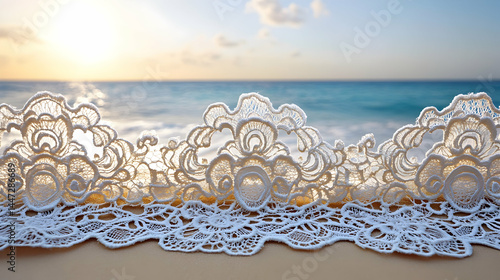 Delicate white lace trim borders a beach scene, with sunlit waves and sky in soft focus