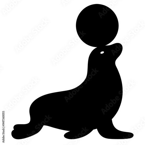 Silhouette of a sea lion balancing a black ball on its head