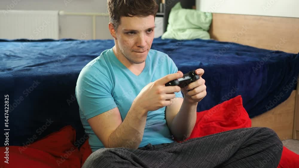 A young attractive man plays a console. A young attractive man plays a console.