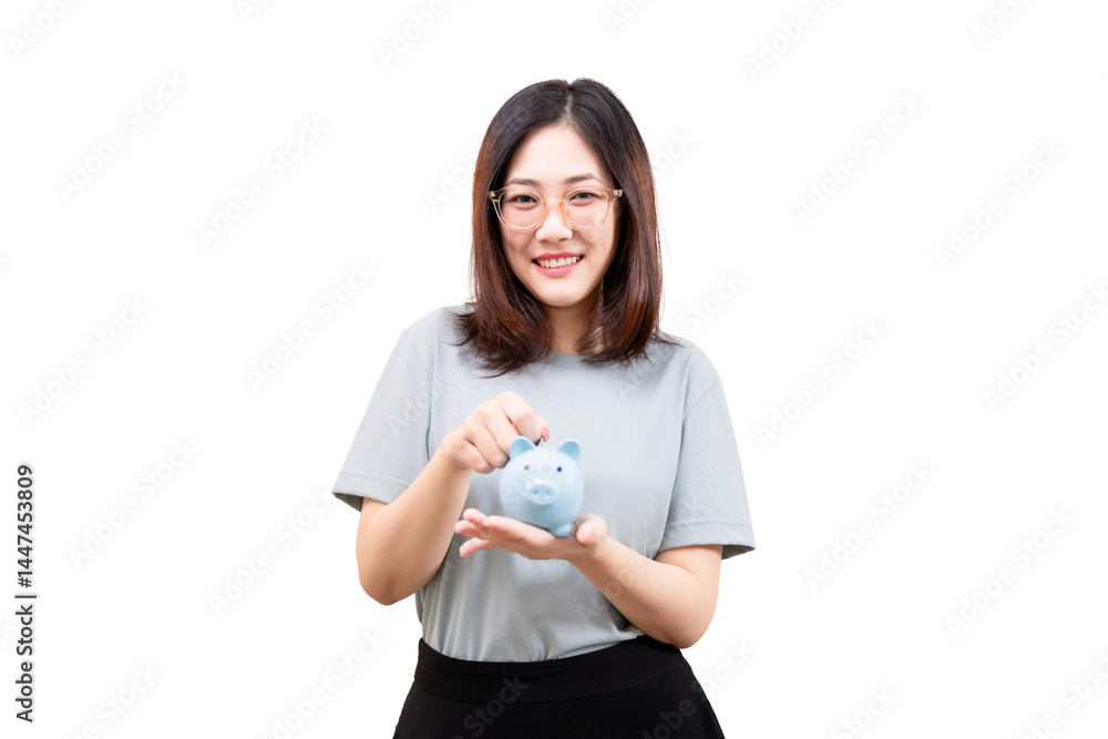 Asian woman smiling while placing a coin into a blue piggy bank. Asian woman smiling while placing a coin into a blue piggy bank.