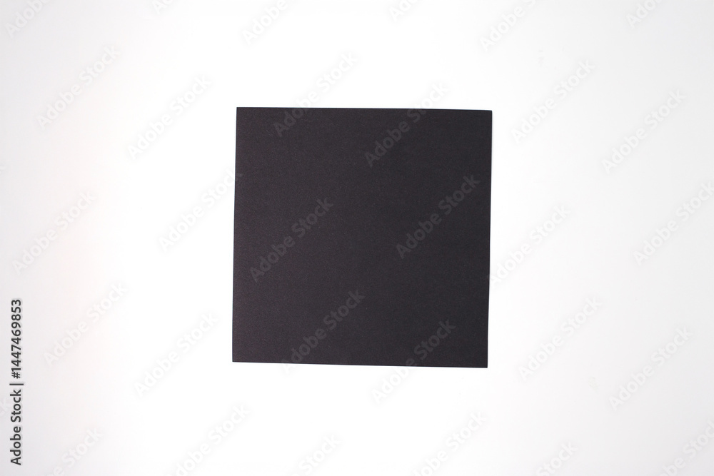 Fototapeta premium Square black paper on white background, basic material for kids paper bat craft, perfect for DIY tutorials, craft kits, educational content, hobby brands, and seasonal creative projects,