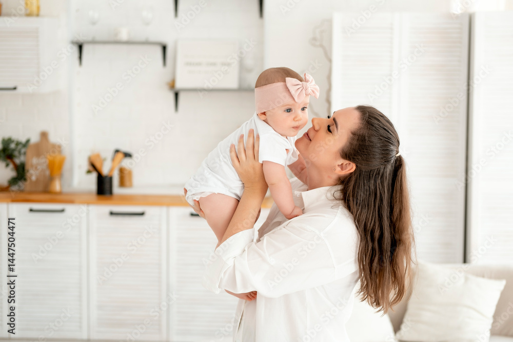 mom and baby hug and kiss at home in the bedroom, parental love and care, happy motherhood, mom with a baby in her arms, space for text mom and baby hug and kiss at home in the bedroom, parental love and care, happy motherhood, mom with a baby in her arms, space for text