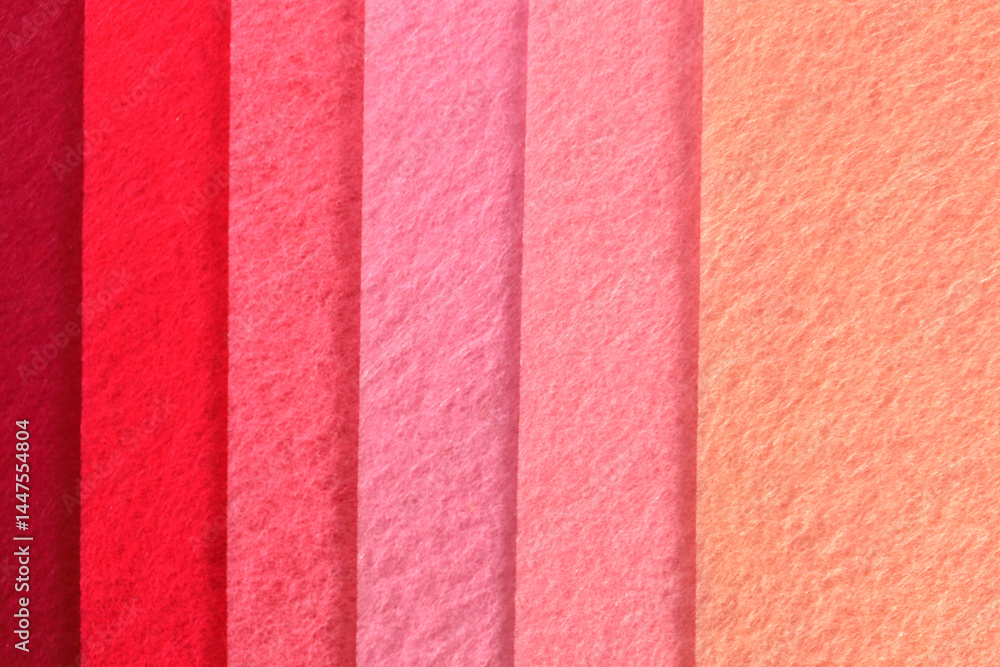 Fototapeta premium Different shades of pink felt folded vertically on top of each other. From dark pink to light pink.