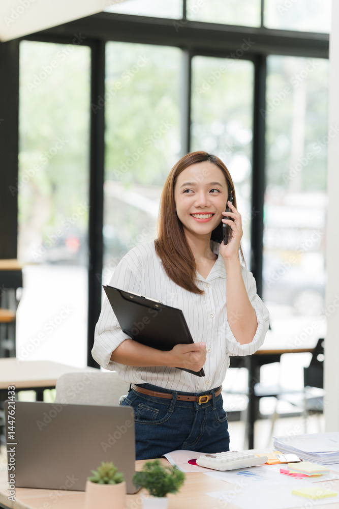 Smiling Woman Talking on Phone in Office Smiling Woman Talking on Phone in Office