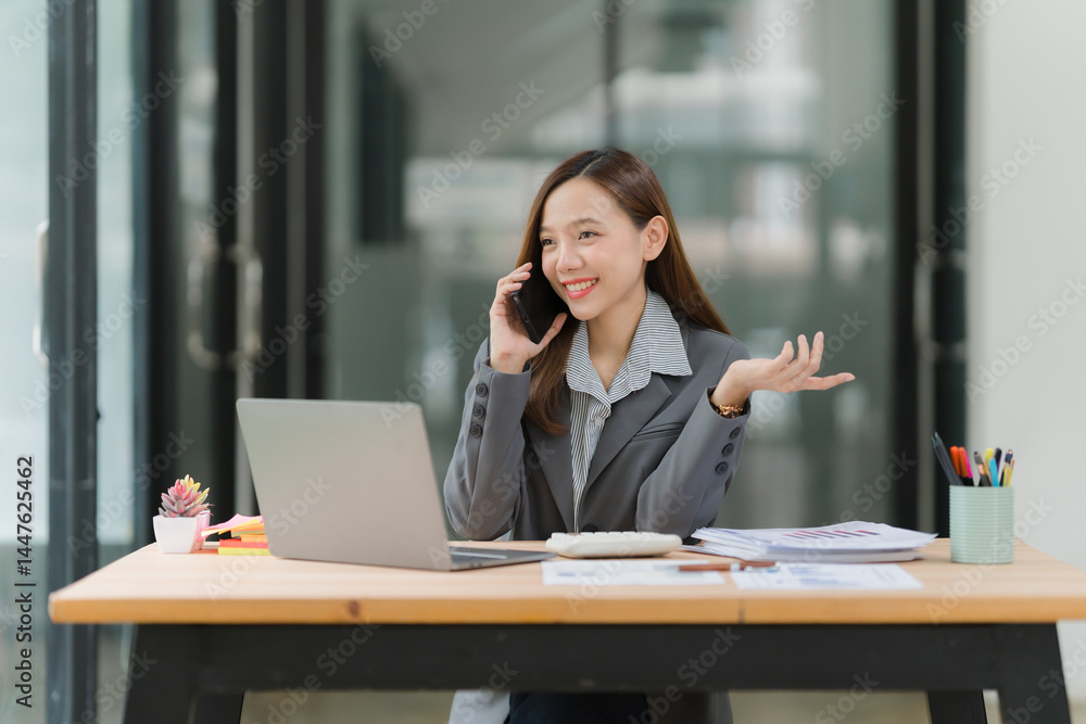 Smiling Businesswoman Talking on Phone at Desk Smiling Businesswoman Talking on Phone at Desk