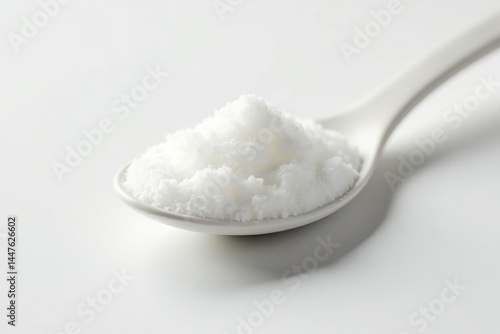 Spoonful of white sugar against white backdrop, white, isolated, glossy