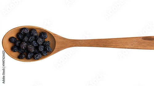 Wooden Spoon Full of Black Raisins, Isolated on White Background