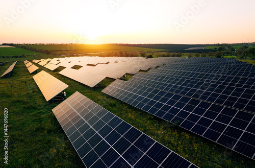 Aerial view of a solar farm generating solar energy.Solar panels park generating green energy electric at sunset.Green energy reduce carbon emissions and makes earth cleaner and more ecological.	
