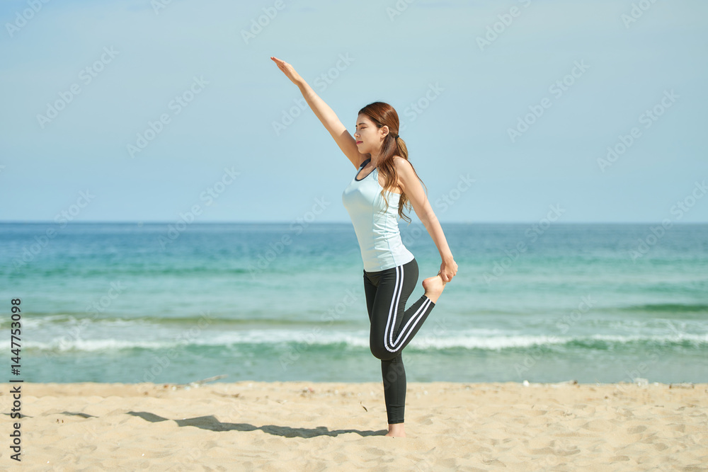 Young Woman Practicing Yoga and Stretching on Beach Young Woman Practicing Yoga and Stretching on Beach