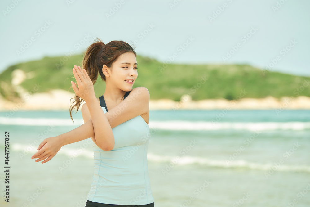 Energetic Young Woman Stretching on the Beach Energetic Young Woman Stretching on the Beach