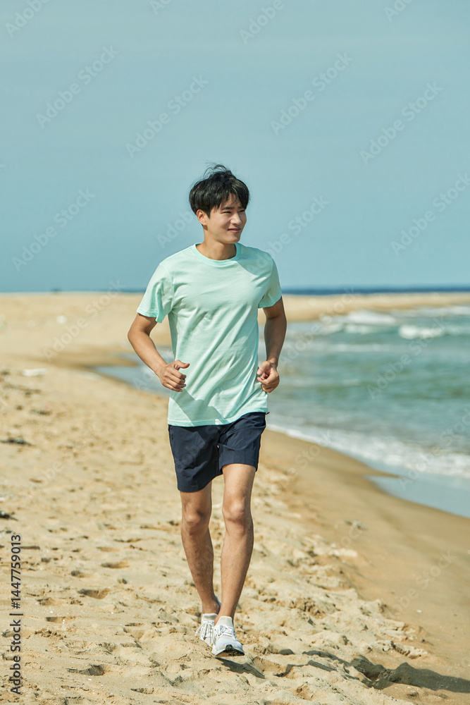 Young Man Jogging on Sandy Beach Young Man Jogging on Sandy Beach