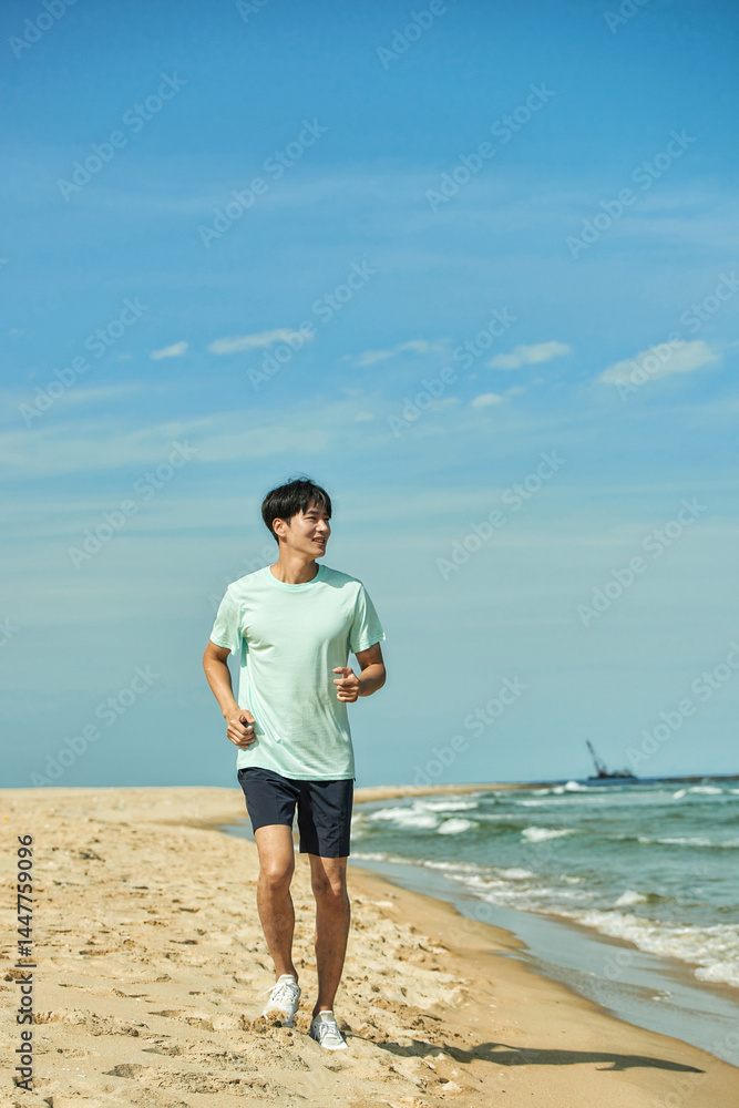 Young Man Jogging on Sandy Beach Young Man Jogging on Sandy Beach