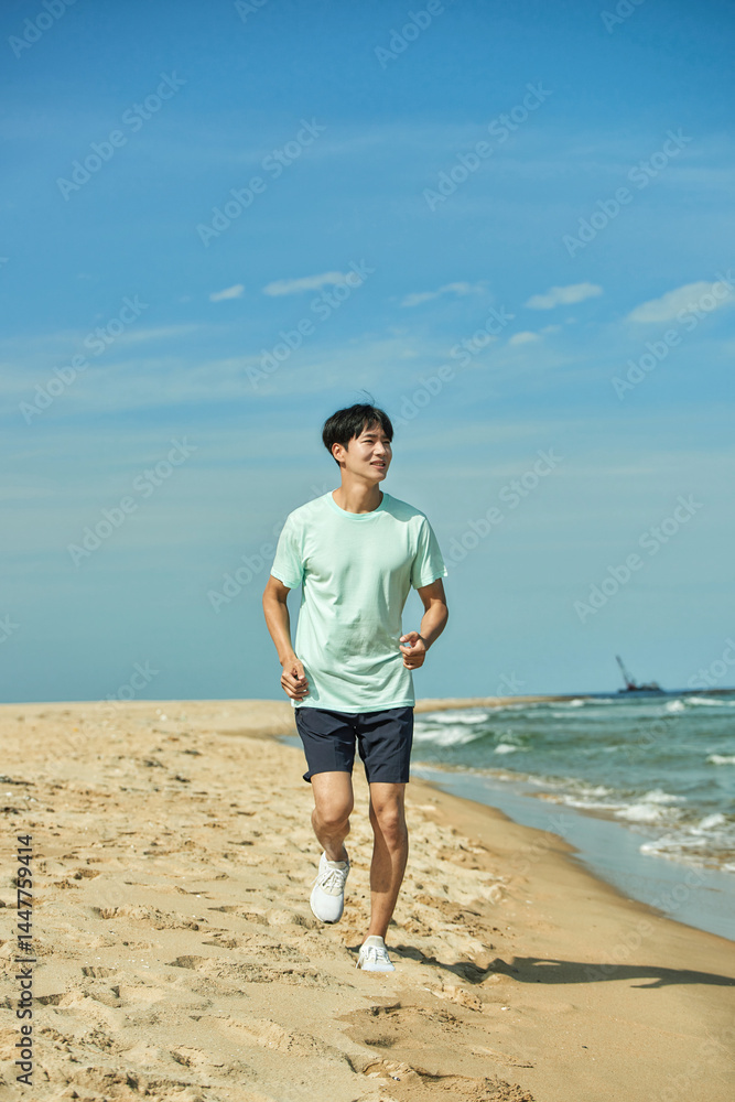 Young Man Jogging on Sandy Beach Young Man Jogging on Sandy Beach
