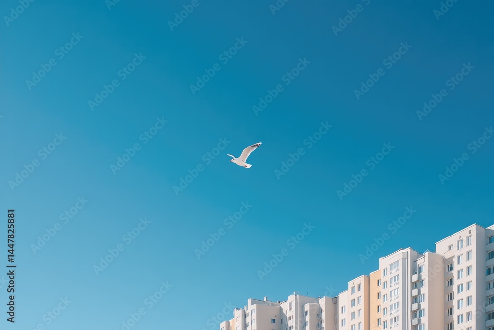 Naklejka premium tall residential buildings stand against clear blue sky