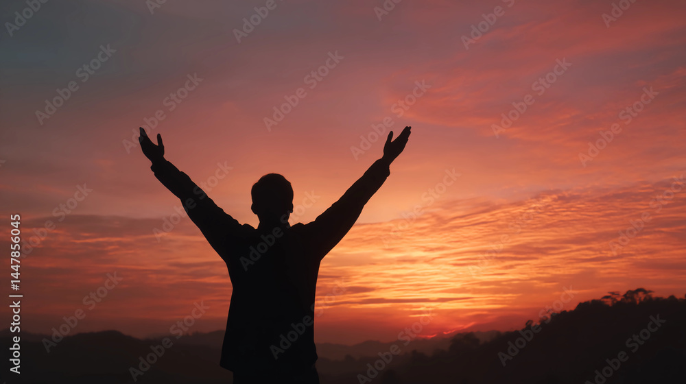 Silhouette of person raising arms in triumph at sunrise Silhouette of person raising arms in triumph at sunrise