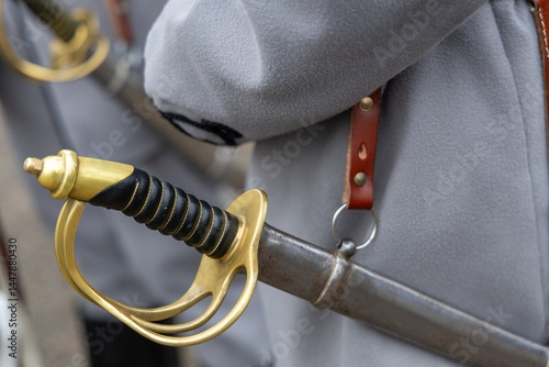 Close-up of historical sword hilt and scabbard in military uniform