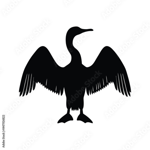 Silhouette of a cormorant bird with wings spread, drying in the sun