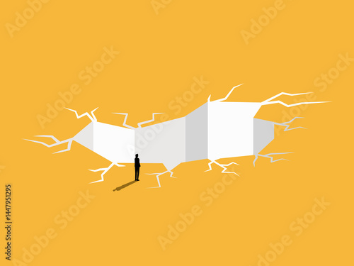 Businessman standing solving the problem of the earth cracking into a hole