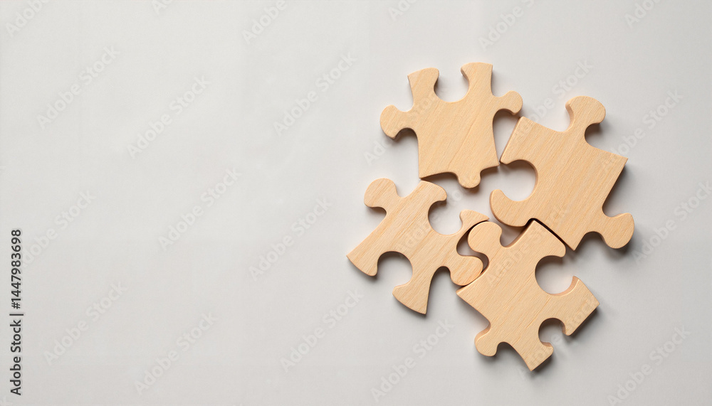 Fototapeta premium Wooden puzzle pieces on light gray background