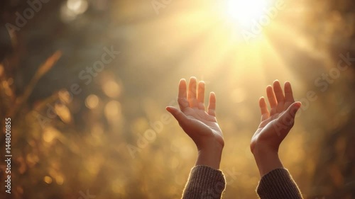 Hands Raised in Prayer: Two hands raised towards a radiant sun, symbolizing hope, faith, and gratitude in a serene natural setting.