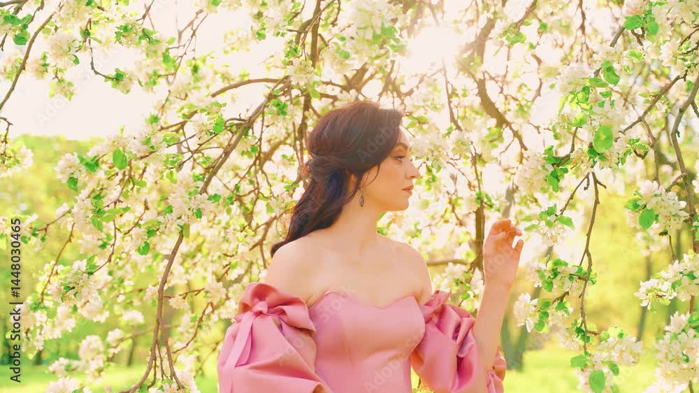 fantasy woman queen hand touching branch blooming tree white apple flowers green fruit garden sun rays light flare.Happy girl beauty face enjoy spring nature day health concept freedom from allergies