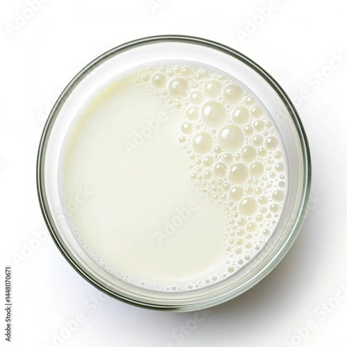 milk in a glass bowl top down view on a white background