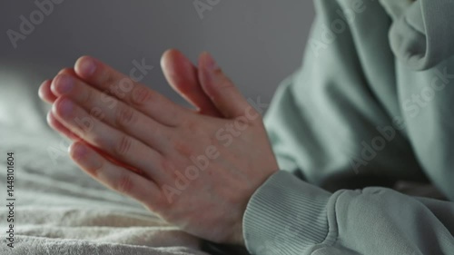 Close-up of a man stroking his hands against each other, mulling something over