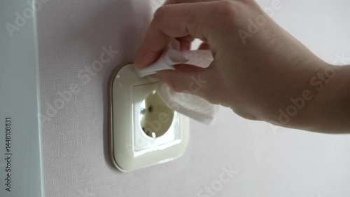The final touch after general cleaning, wiping the outlet with a damp cloth