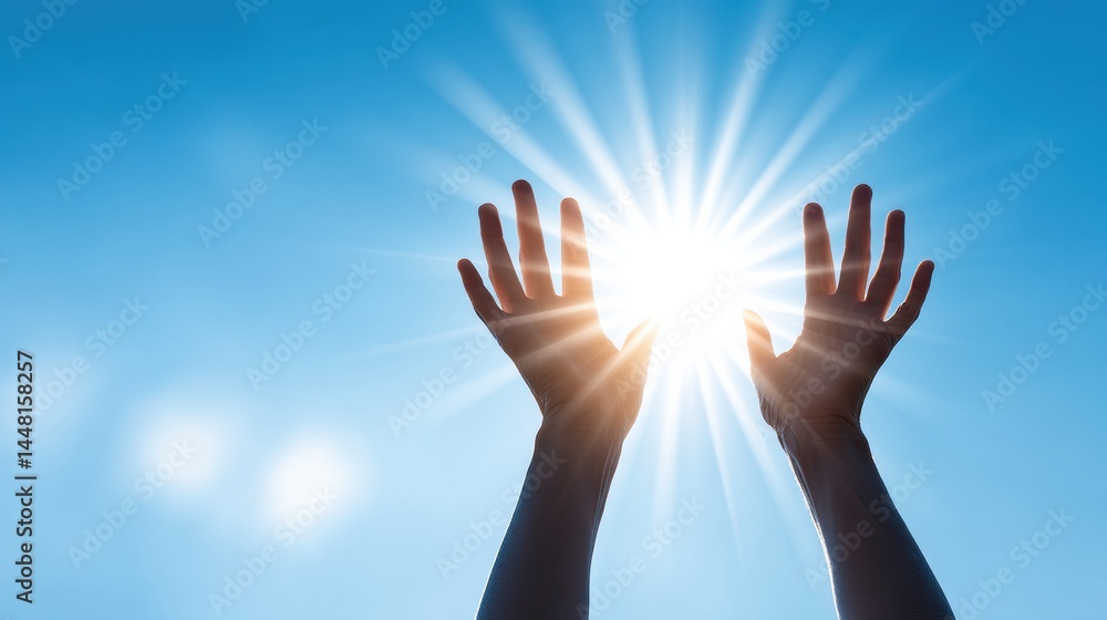 Two hands reach up toward a bright sun in a clear blue sky, with sunlight streaming between the fingers. Two hands reach up toward a bright sun in a clear blue sky, with sunlight streaming between the fingers.