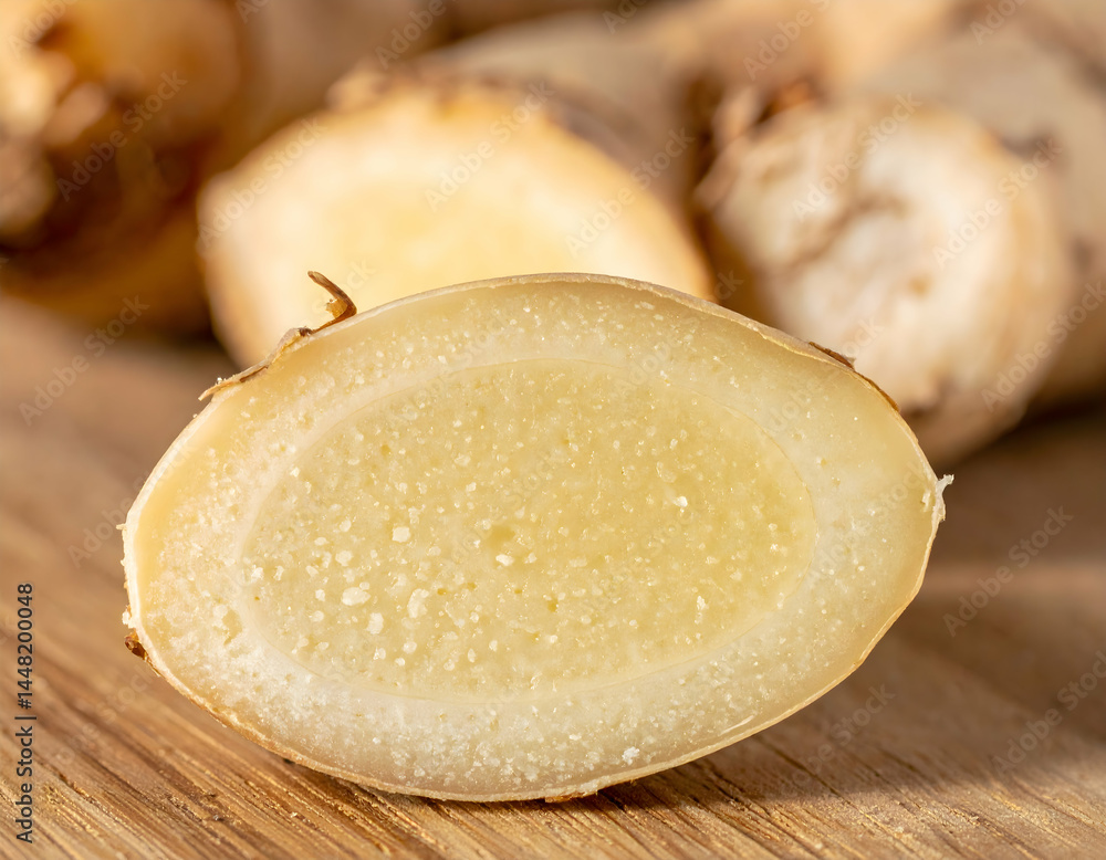Closeup Of Sliced Ginger Root On Wooden Surface Closeup Of Sliced Ginger Root On Wooden Surface