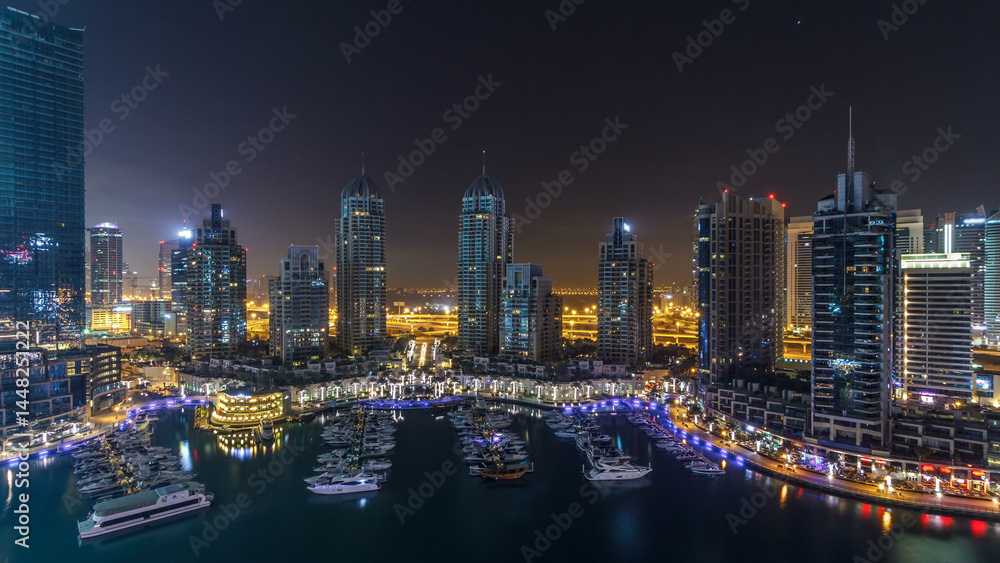 Fototapeta premium Dubai Marina all night timelapse, Glittering lights and tallest skyscrapers during a clear evening