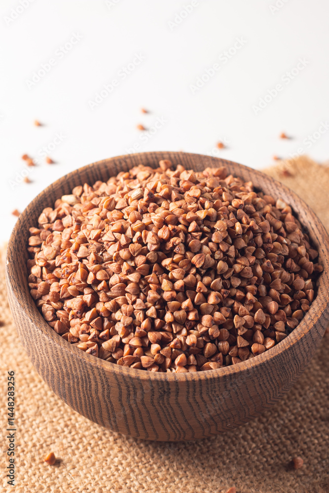 Buckwheat groats on wooden background. Healthy cereal concept. Buckwheat groats on wooden background. Healthy cereal concept.