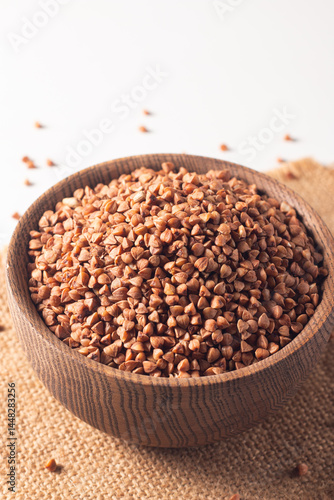 Buckwheat groats on wooden background. Healthy cereal concept.  