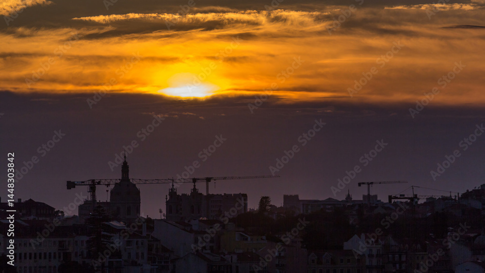 Fototapeta premium Lisbon at sunset aerial view of city centre with orange sky at Autumn evening timelapse, Portugal