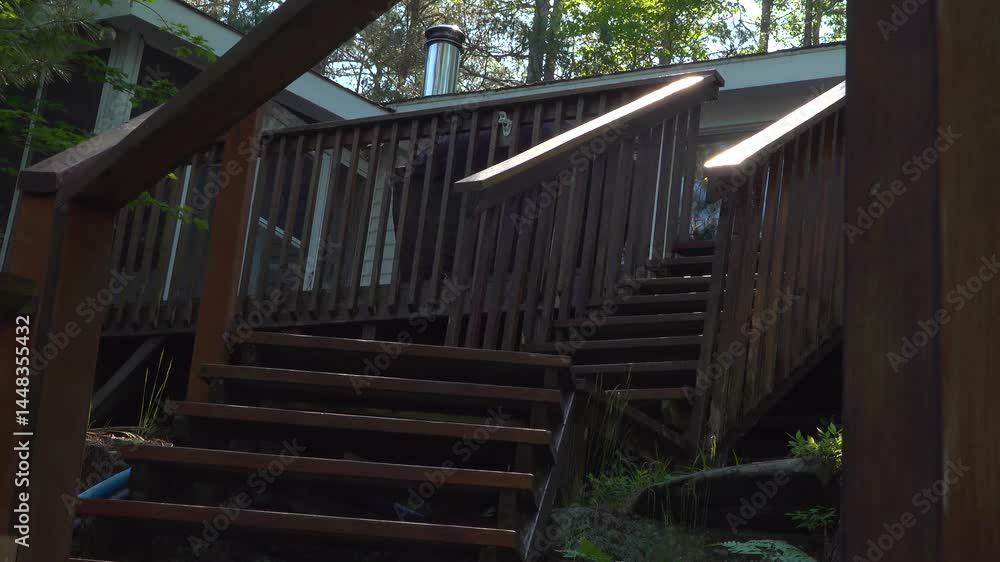 Rustic staircase made of wood ascending to a cottage surrounded by greenery and natural light. Captures the charm of countryside architecture and the tranquility of a forested environment. Rustic staircase made of wood ascending to a cottage surrounded by greenery and natural light. Captures the charm of countryside architecture and the tranquility of a forested environment.