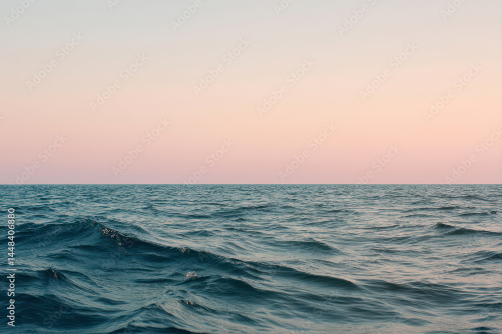Obraz premium Serene Tranquility of Soft Waves and a Pastel Gradient Sky Over a Calm Sea at Dusk