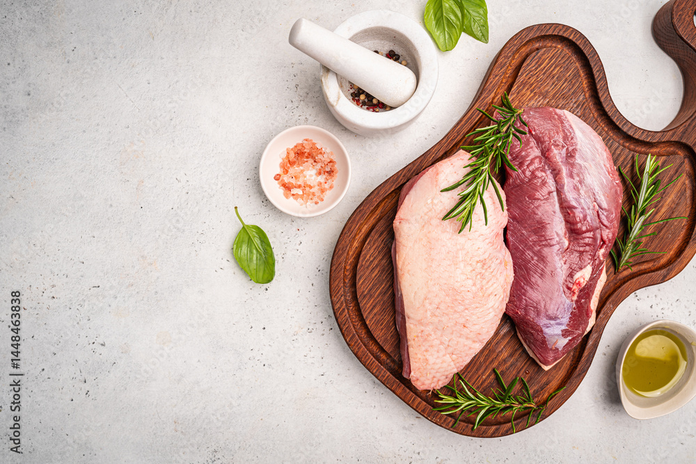 Preparation for cooking raw duck breast with ingredients on white background, top view. Space for text. High quality photo