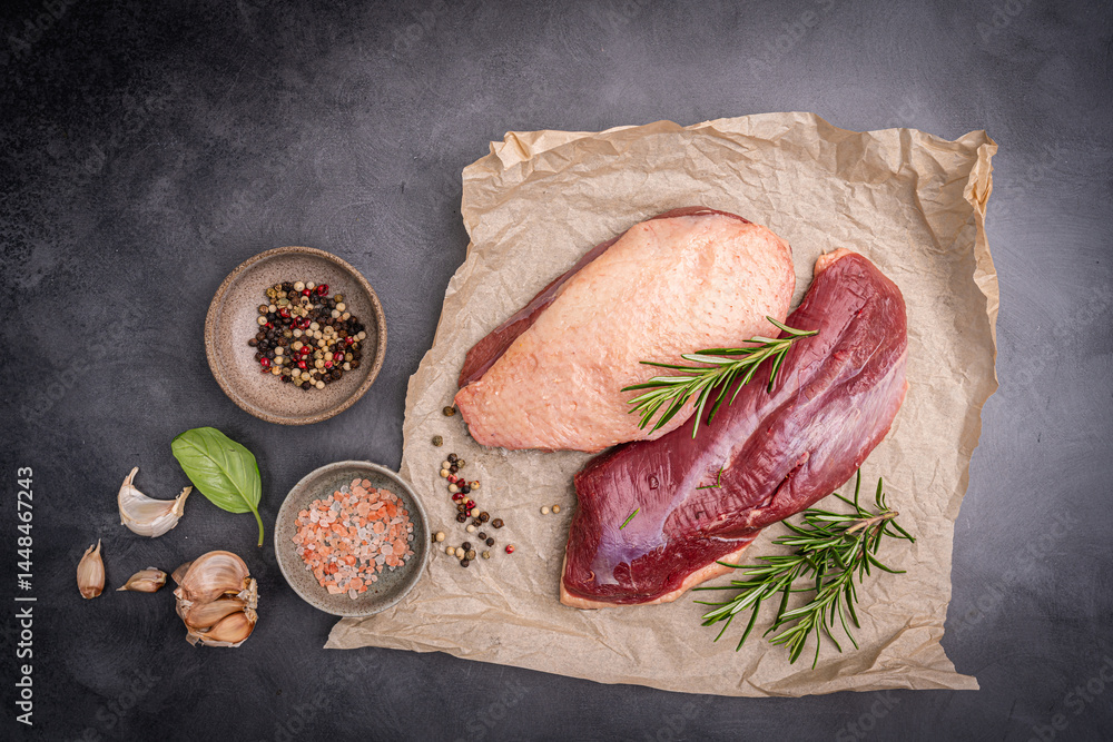 Preparation for cooking raw duck breast with ingredients on dark background, top view. Space for text. High quality photo
