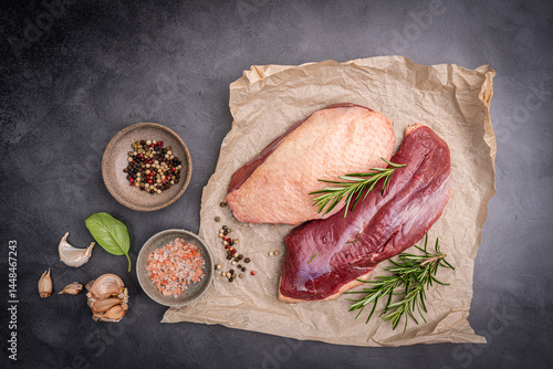 Obraz na płótnie Preparation for cooking raw duck breast with ingredients on dark background, top view. Space for text. High quality photo w salonie