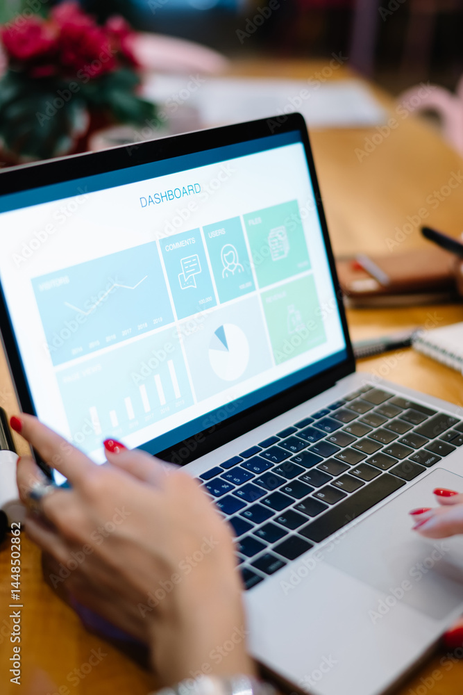 Fototapeta premium Cropped female freelancers analyzing web dashboard during laptop business projecting, skilled women browsing website with infographics statistics during brainstorming meeting for using netbook