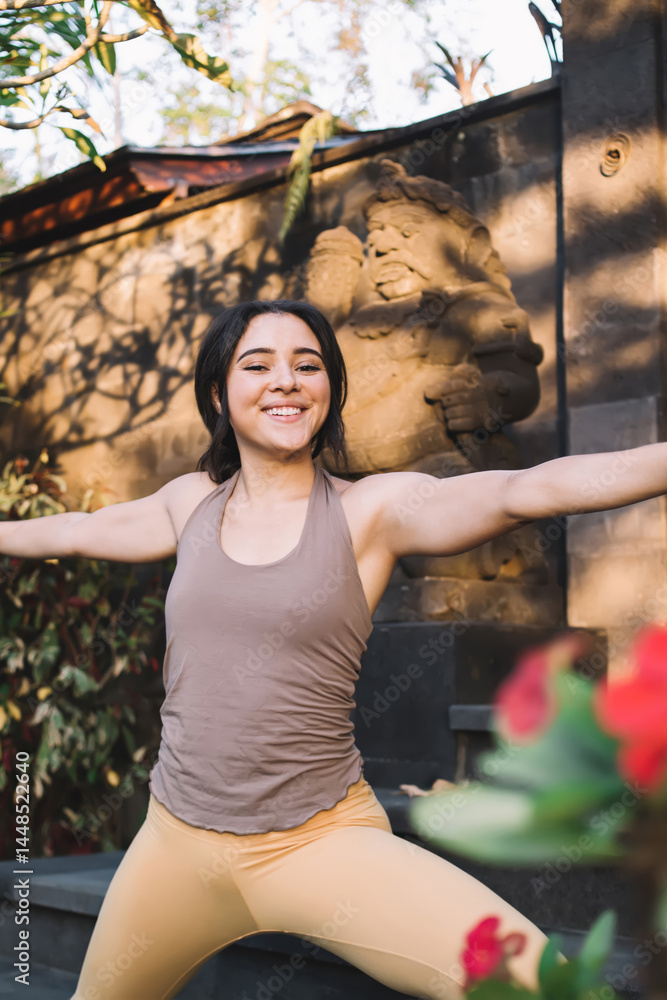 Happy woman practicing yoga in park