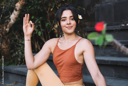 Obraz na płótnie Young female sitting on steps in Ardha Matsyendrasana Pose w salonie