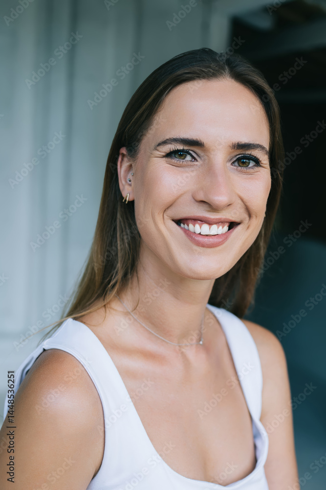 Cheerful young woman smiling and looking at camera