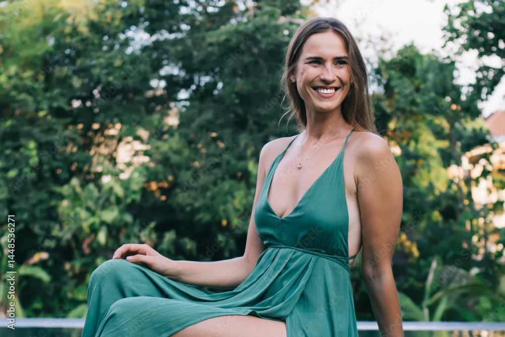 Positive stylish young woman enjoying summer in garden